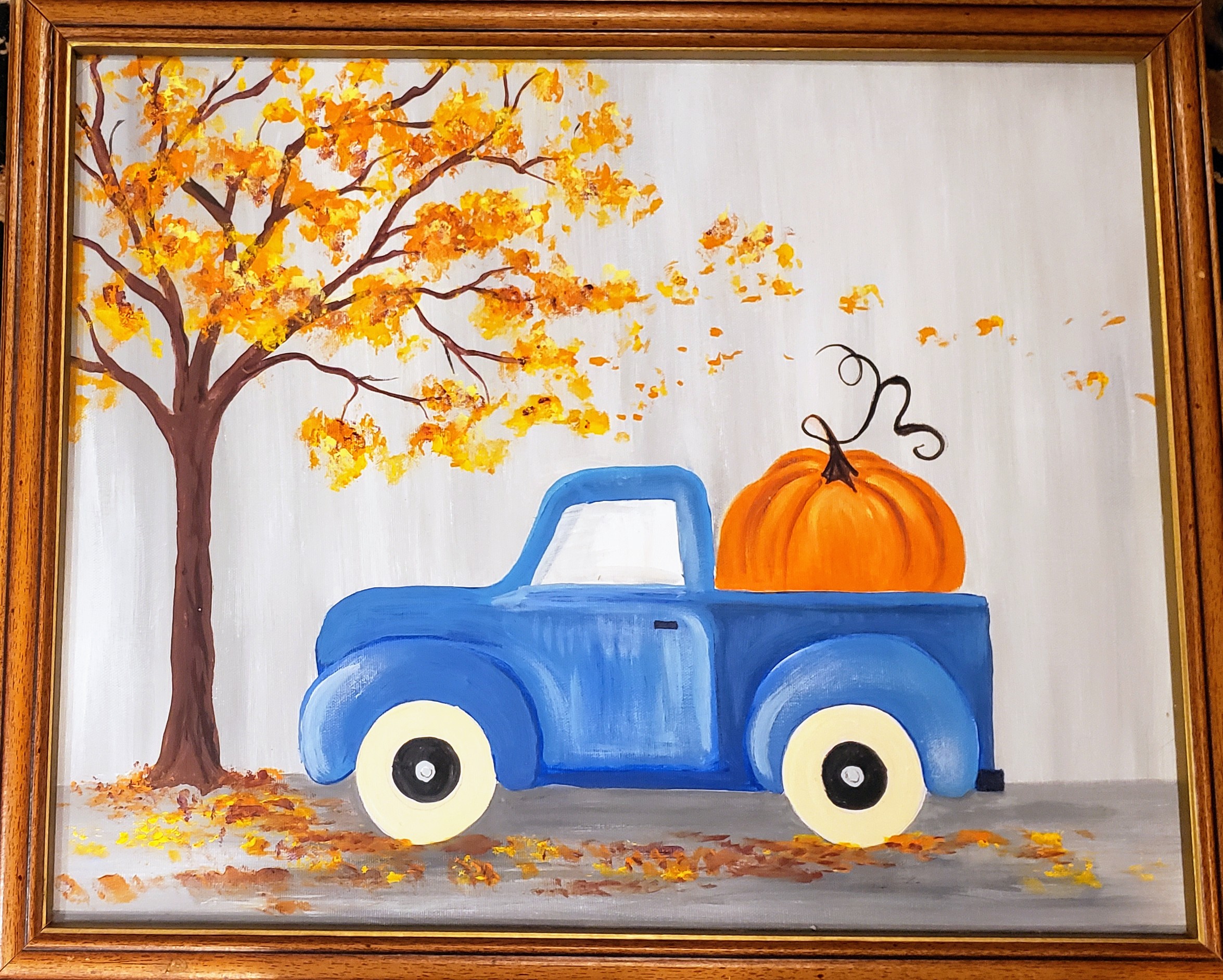 old blue truck with pumpkin on back