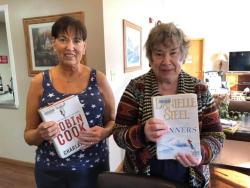 Two women holding books