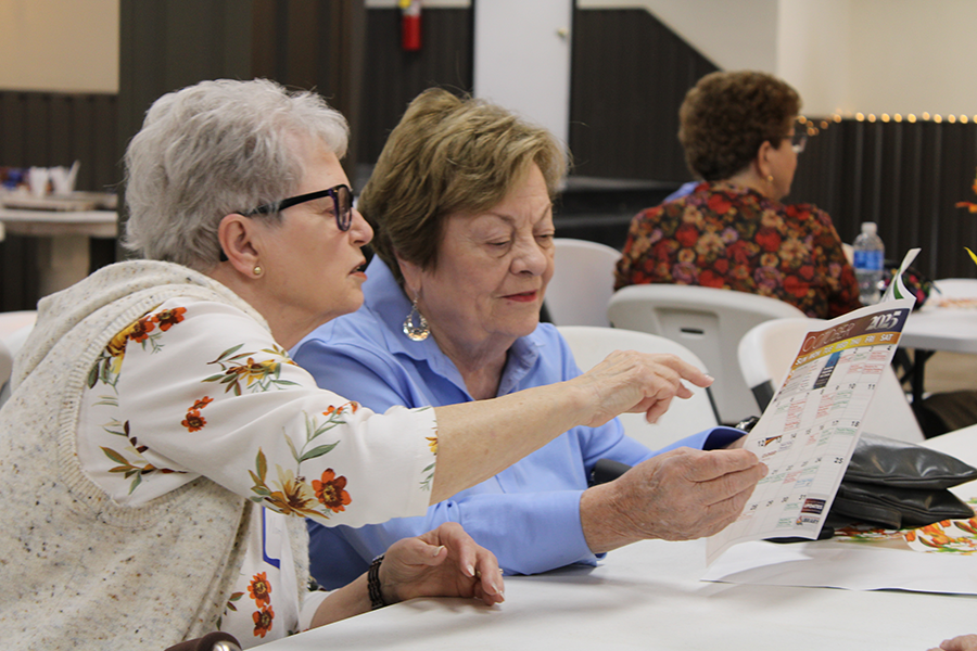 Two women looking at an information brochure during a Friends-sponsored event