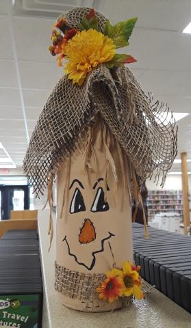 Scarecrow made out of a wine bottle