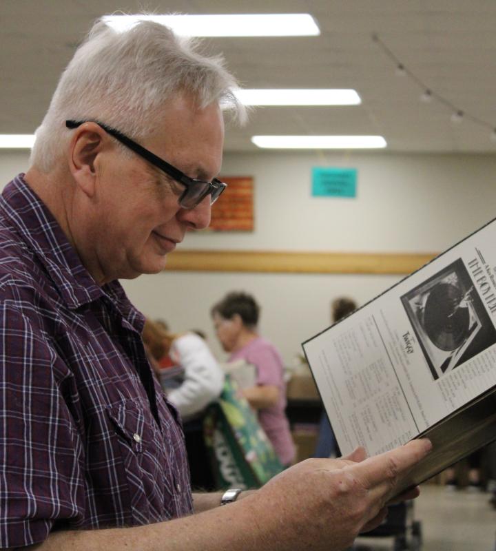 male looking at books