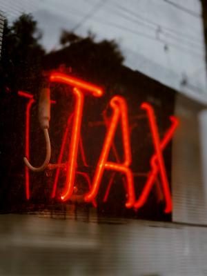 Red lighted sign that says "tax"